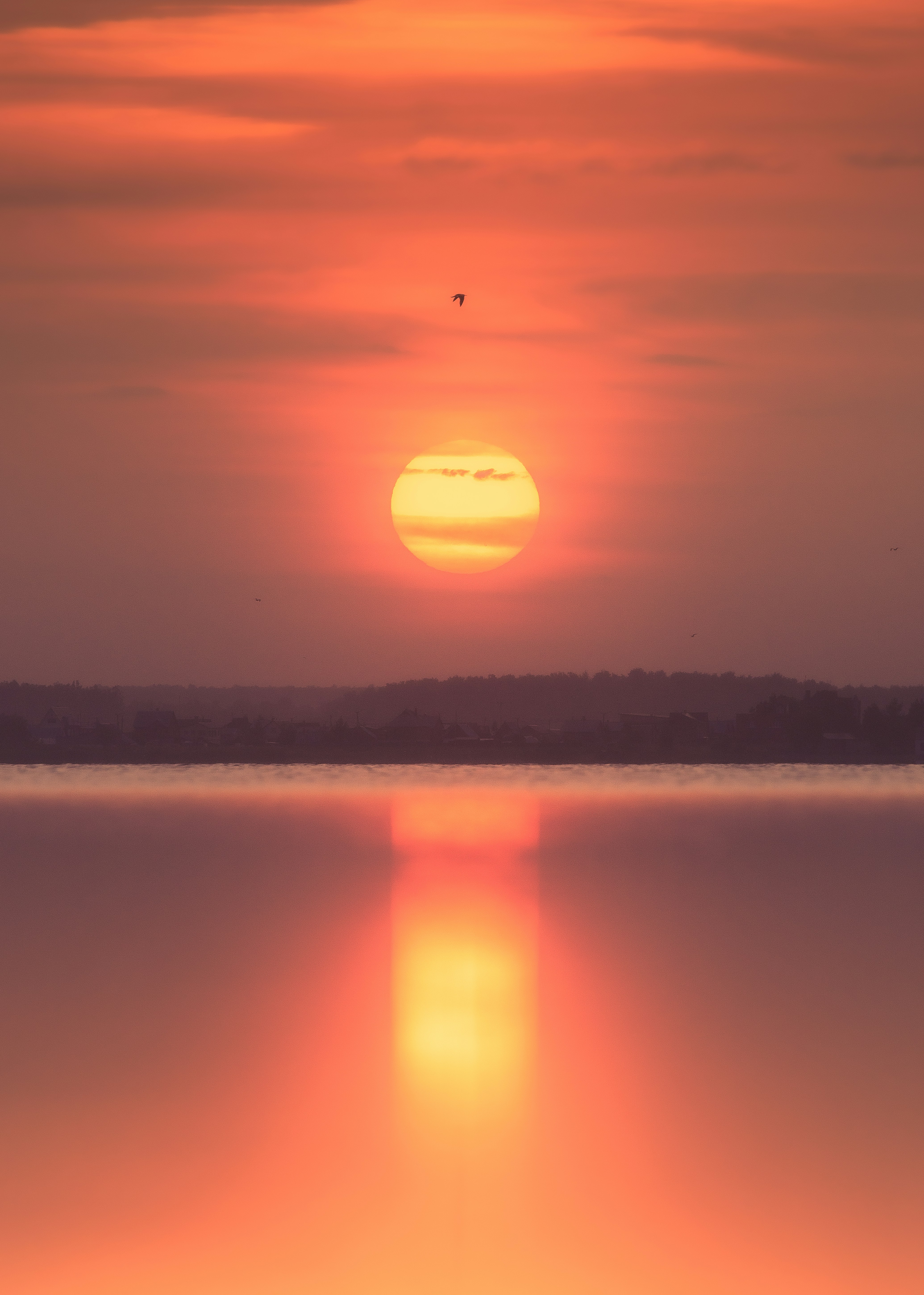 Warm sunset over a calm body of water.