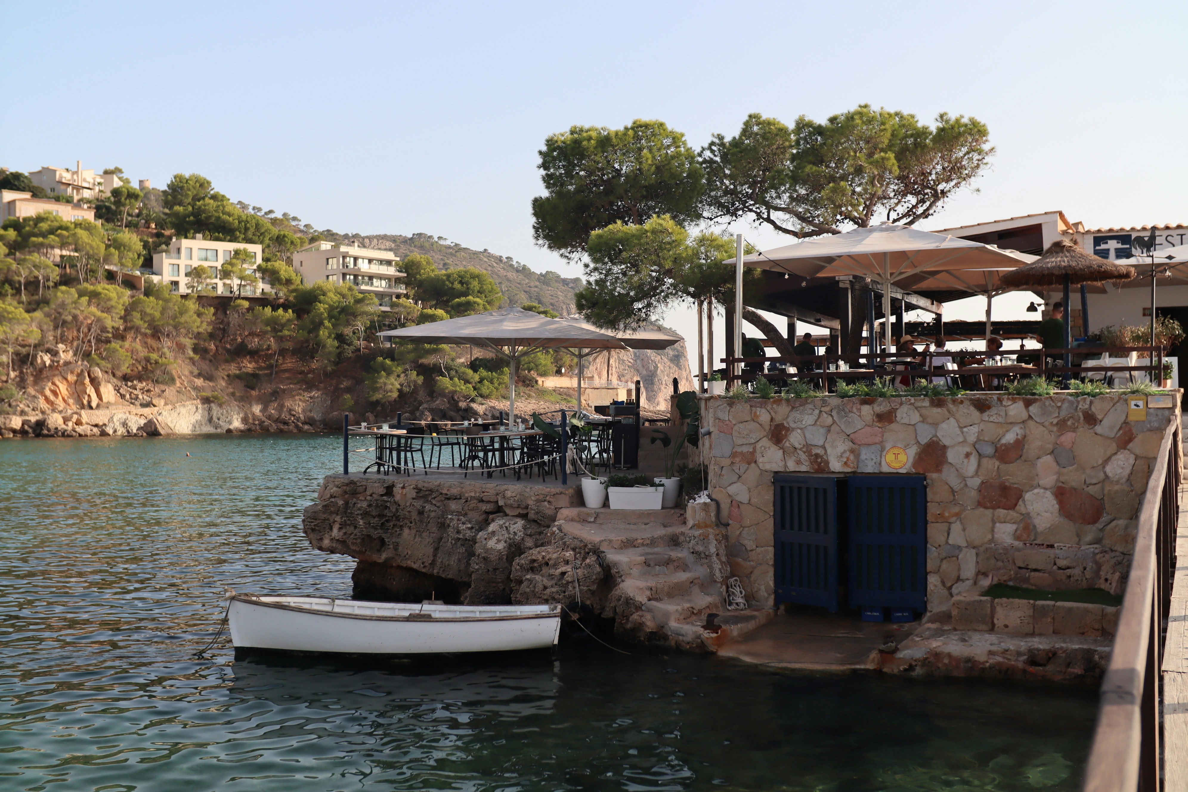 Seaside restaurant with tables overlooking the water.