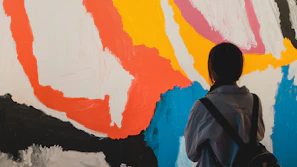 Person looking at a colorful abstract painting