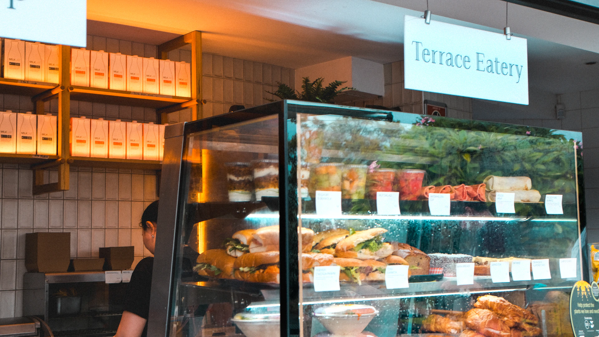 Display case with sandwiches and drinks at terrace eatery