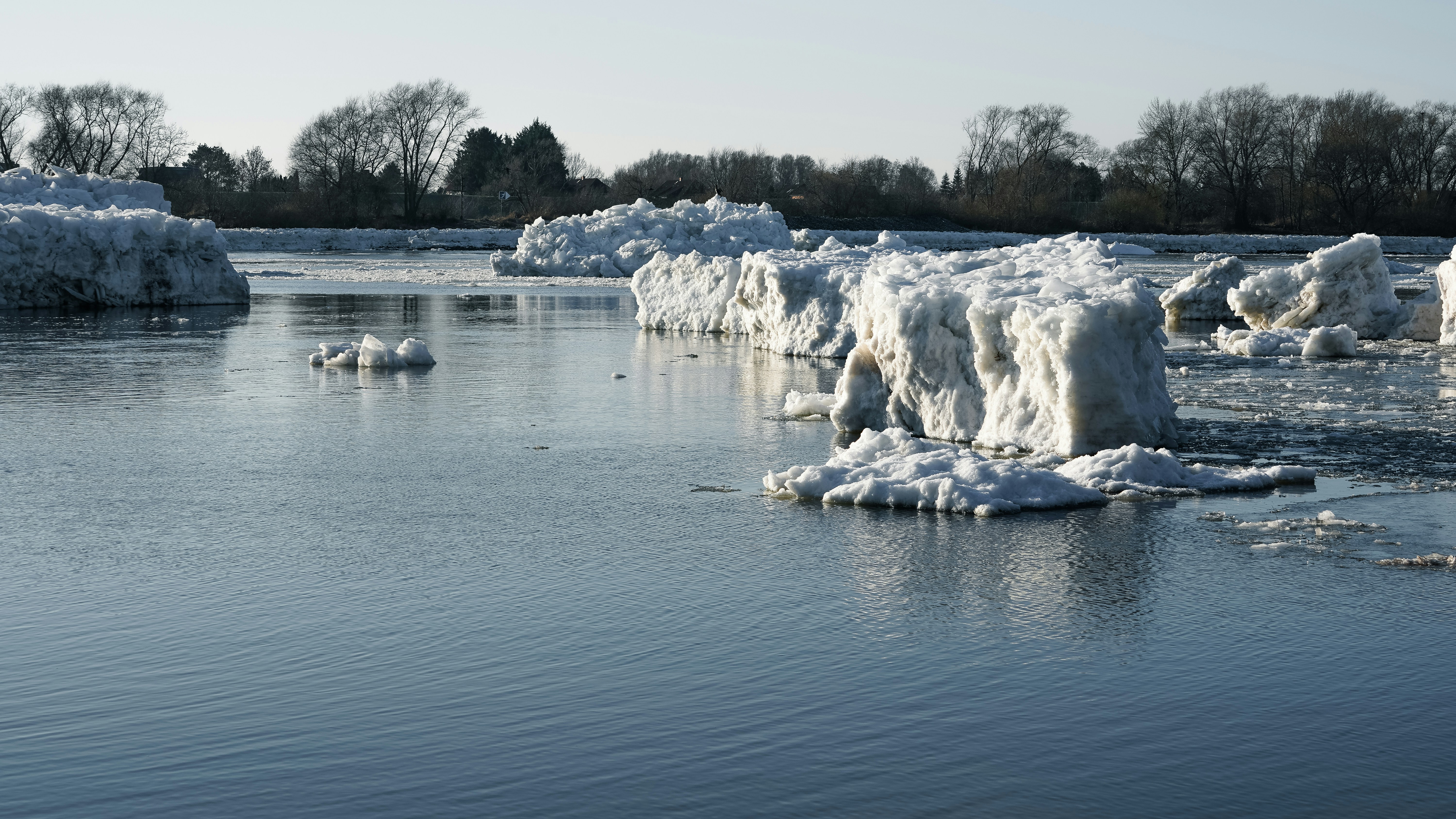 Ice chunks floating on a calm river