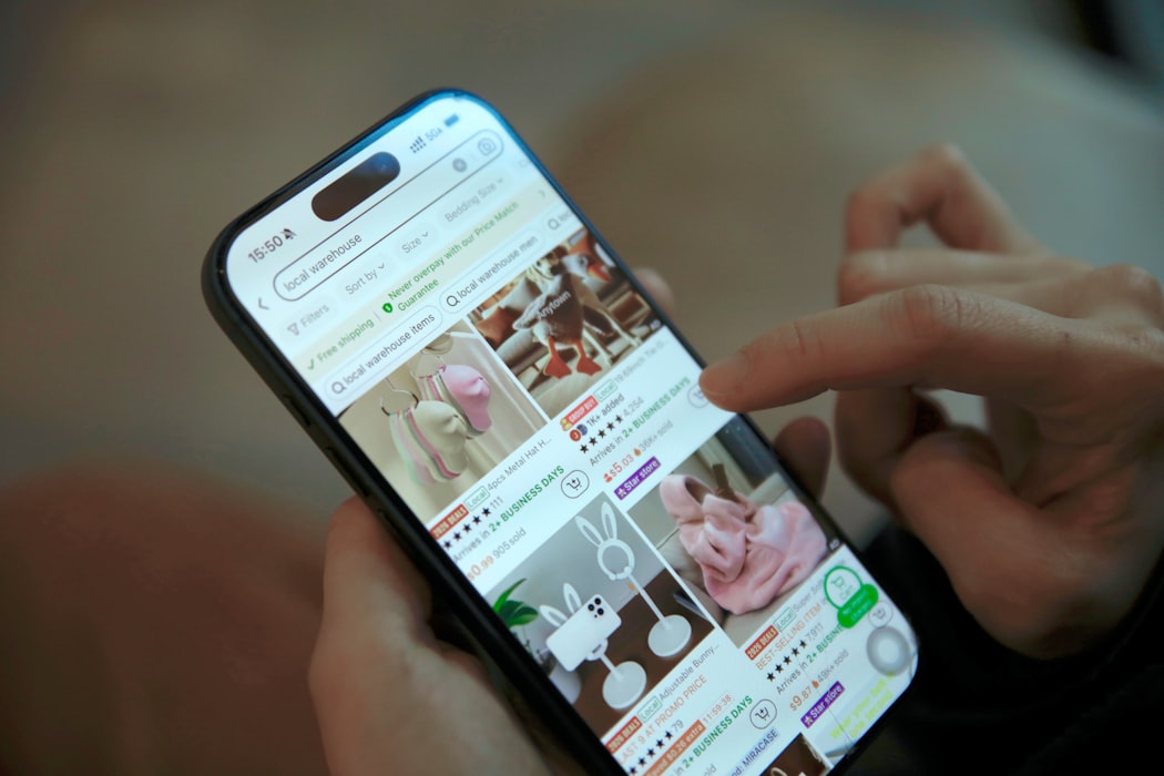 A shopper scrolls through product listings and video content on a smartphone.