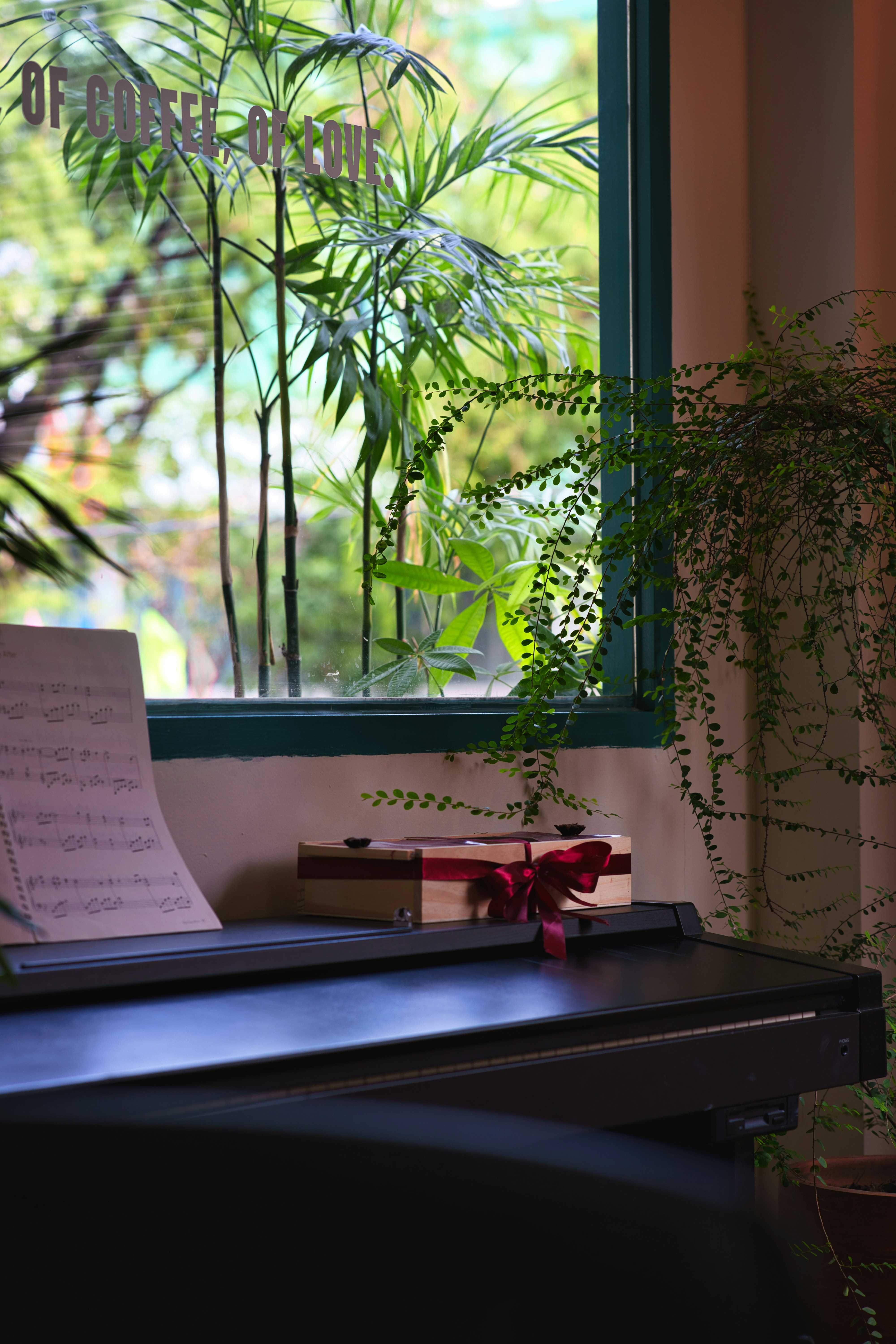 Piano with sheet music and a gift box