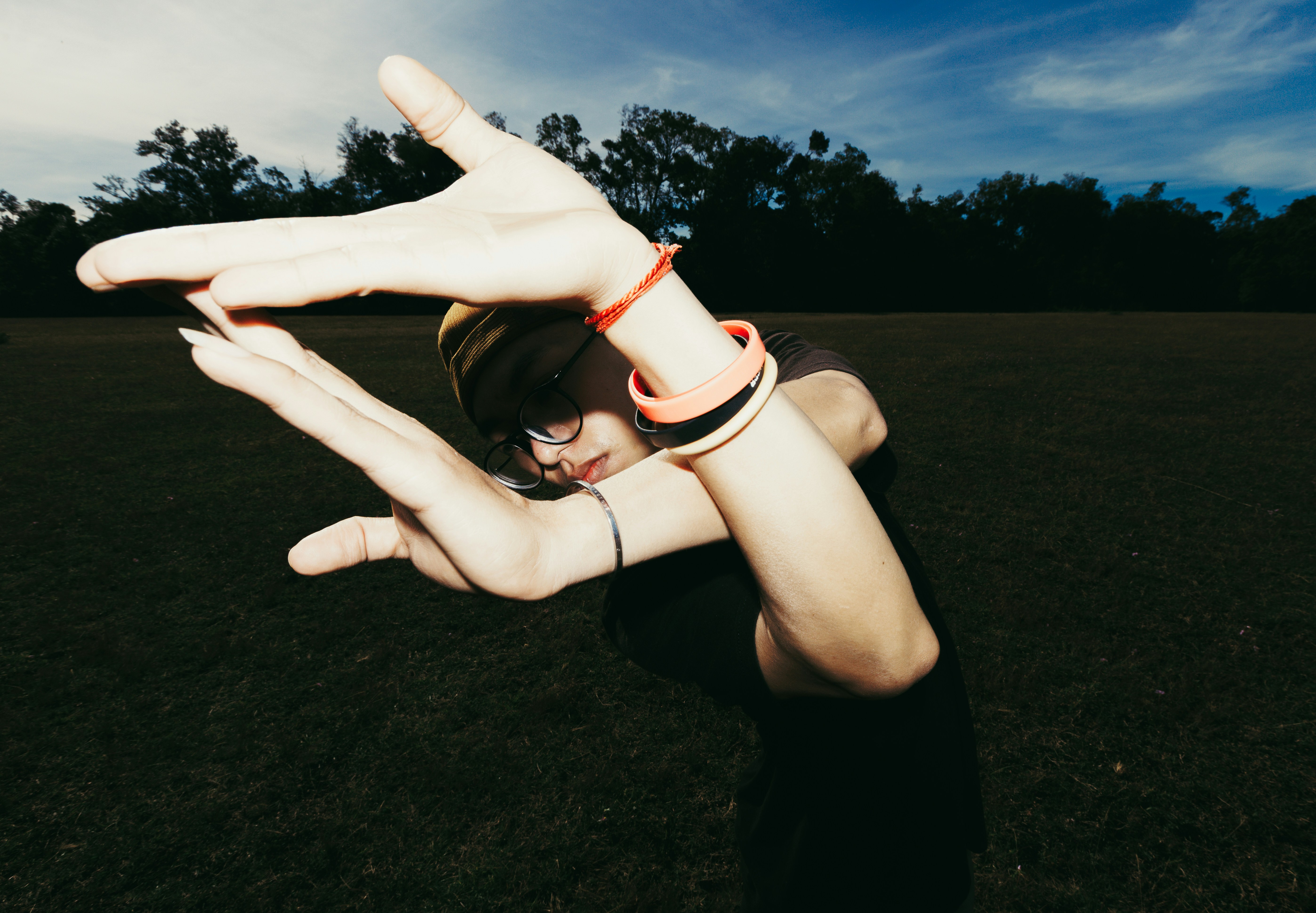 Person forming a shape with arms and hands