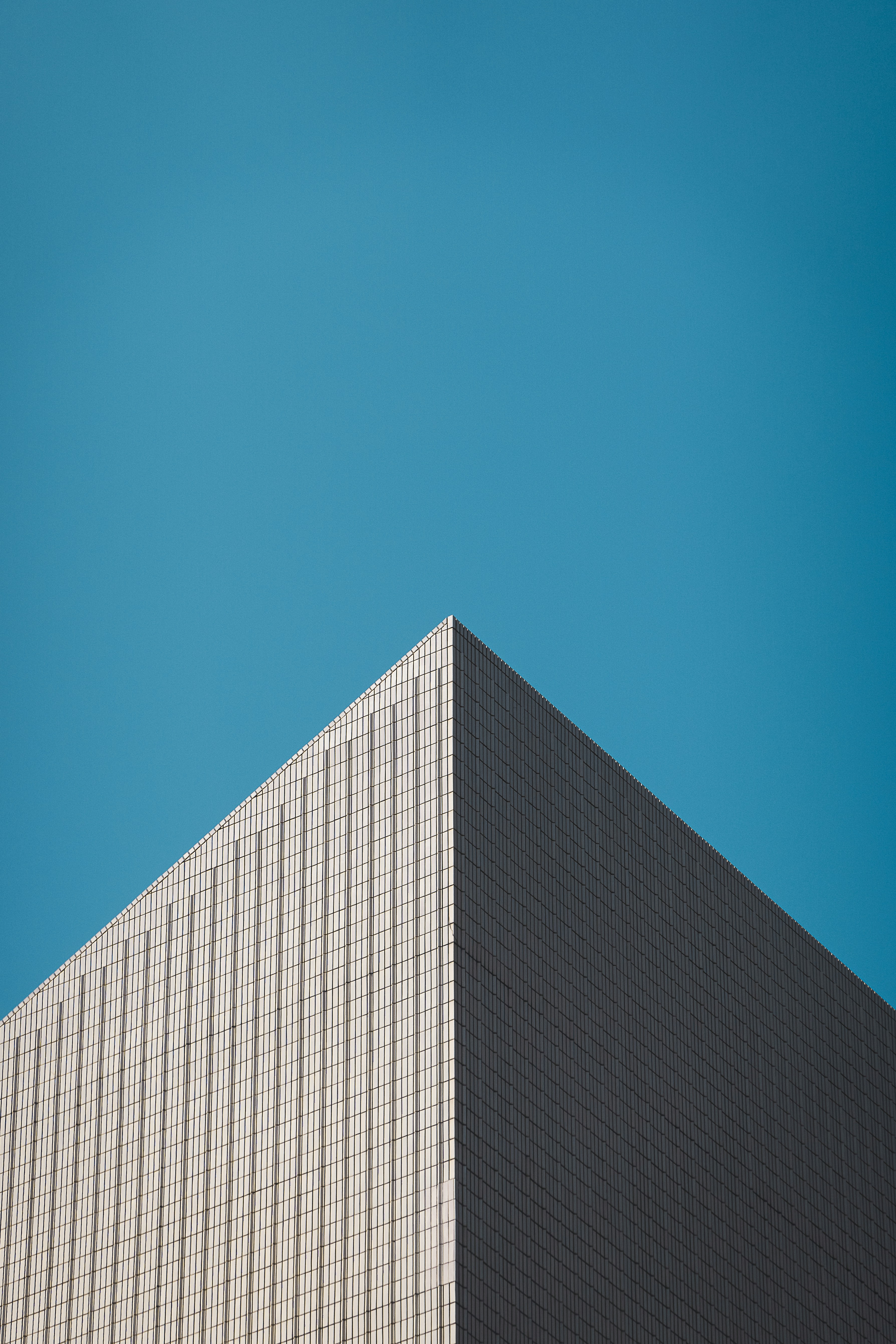 Modern building corner against a clear blue sky