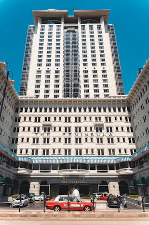 The peninsula hotel entrance with red taxi