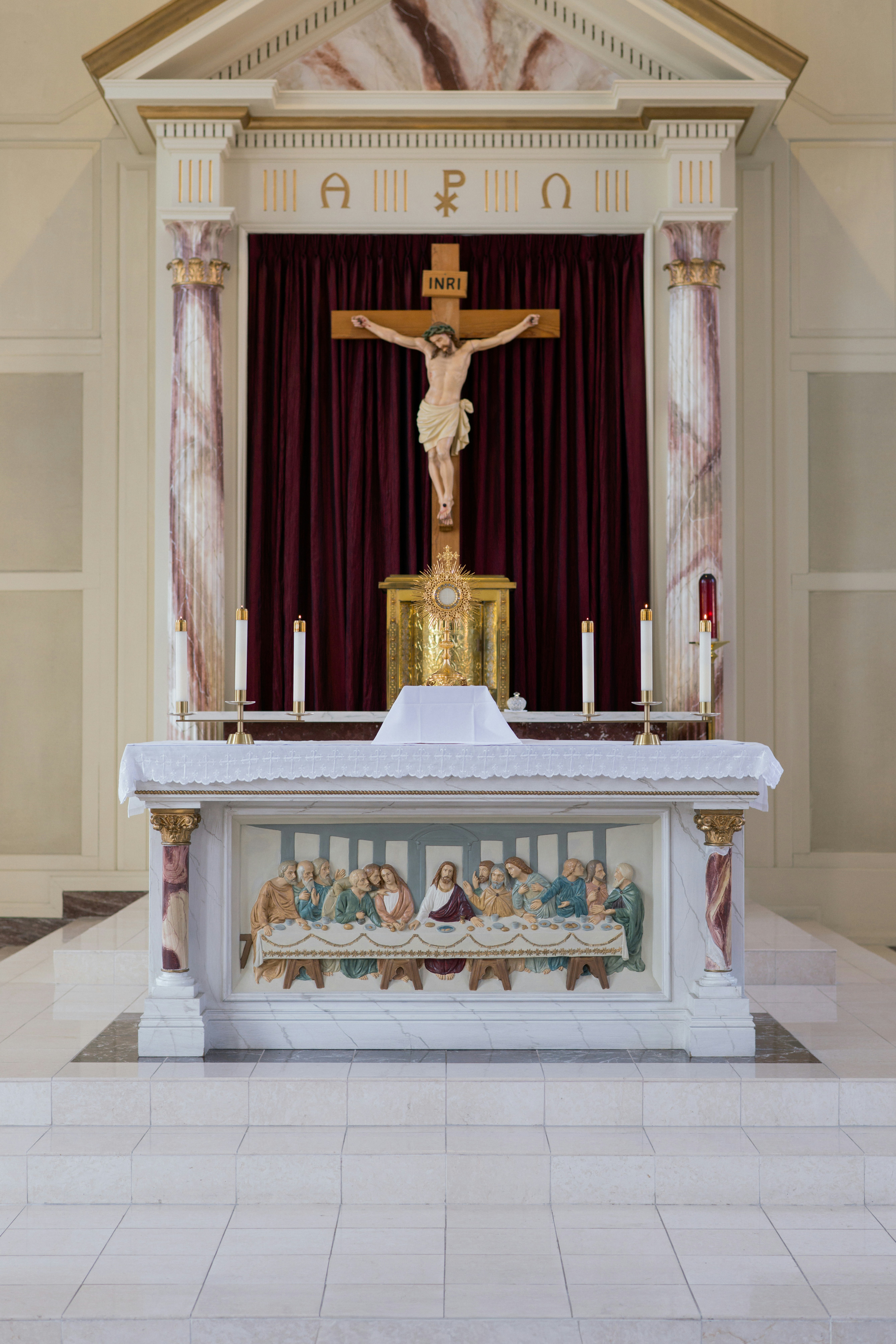 Altar with crucifix and depiction of the last supper.