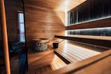 Interior of a modern wooden sauna with stone heater.