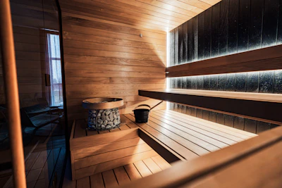 Interior of a modern wooden sauna with stone heater.