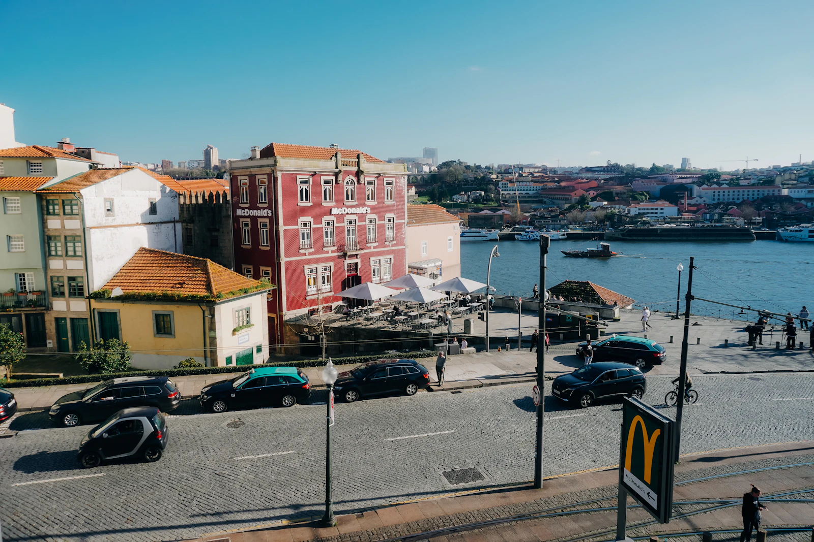 Automóveis numa rua junto ao rio Douro no Porto