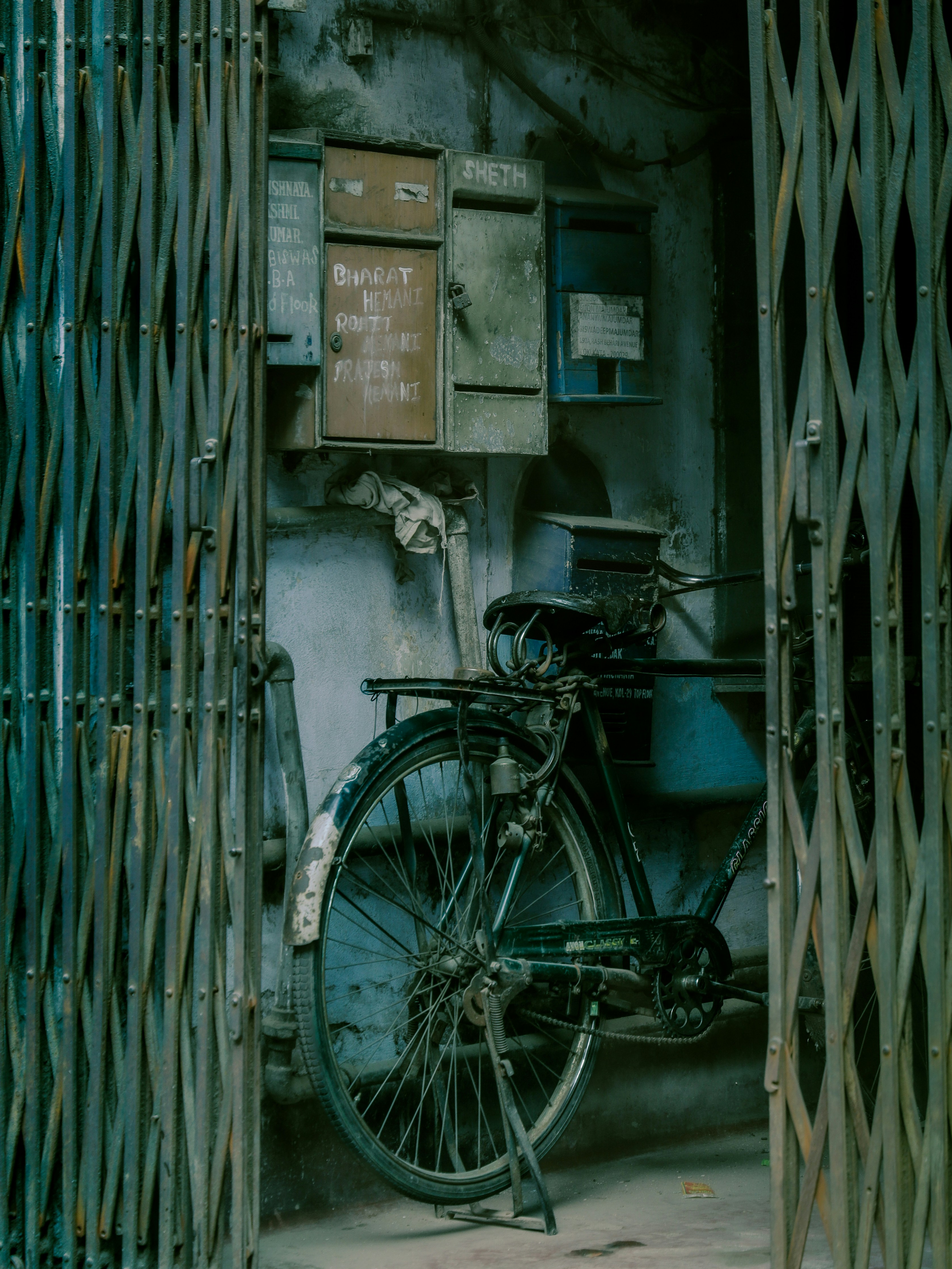 An old bicycle parked near mailboxes