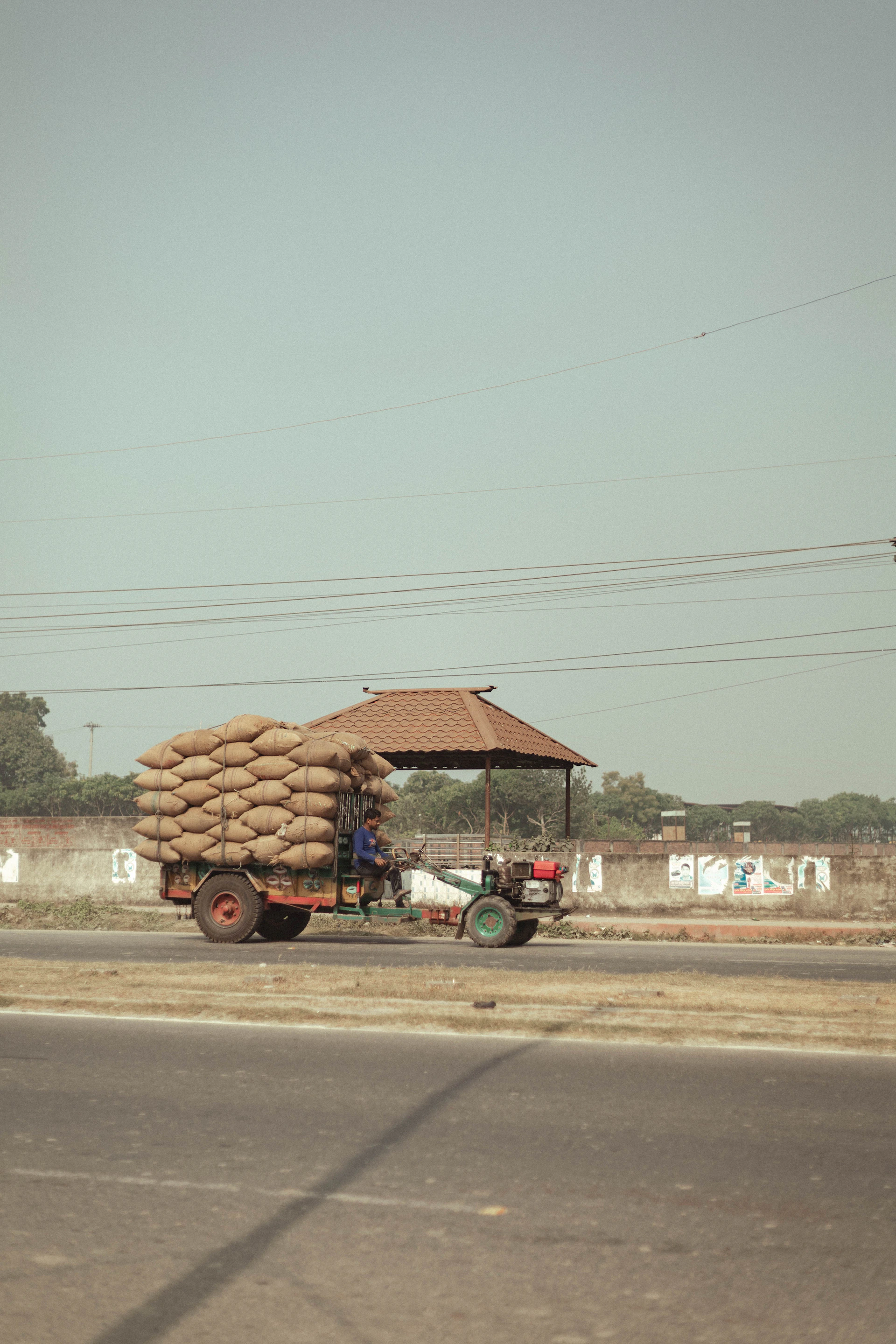 Tractor pulling a cart full of sacks