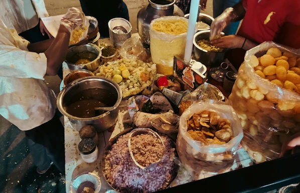 Street food vendor preparing snacks with various ingredients