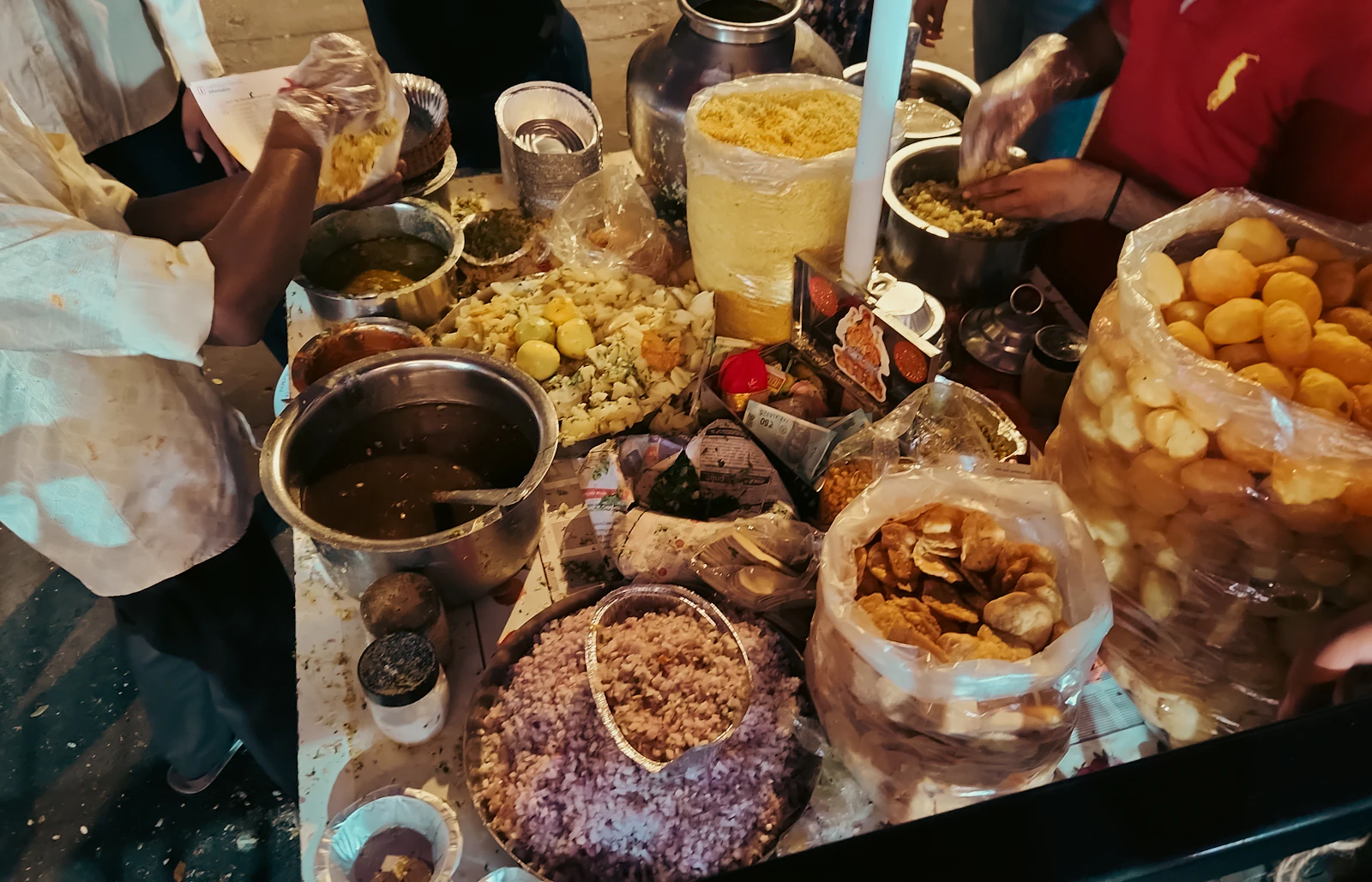 Chaat artist assembling snacks at a live counter