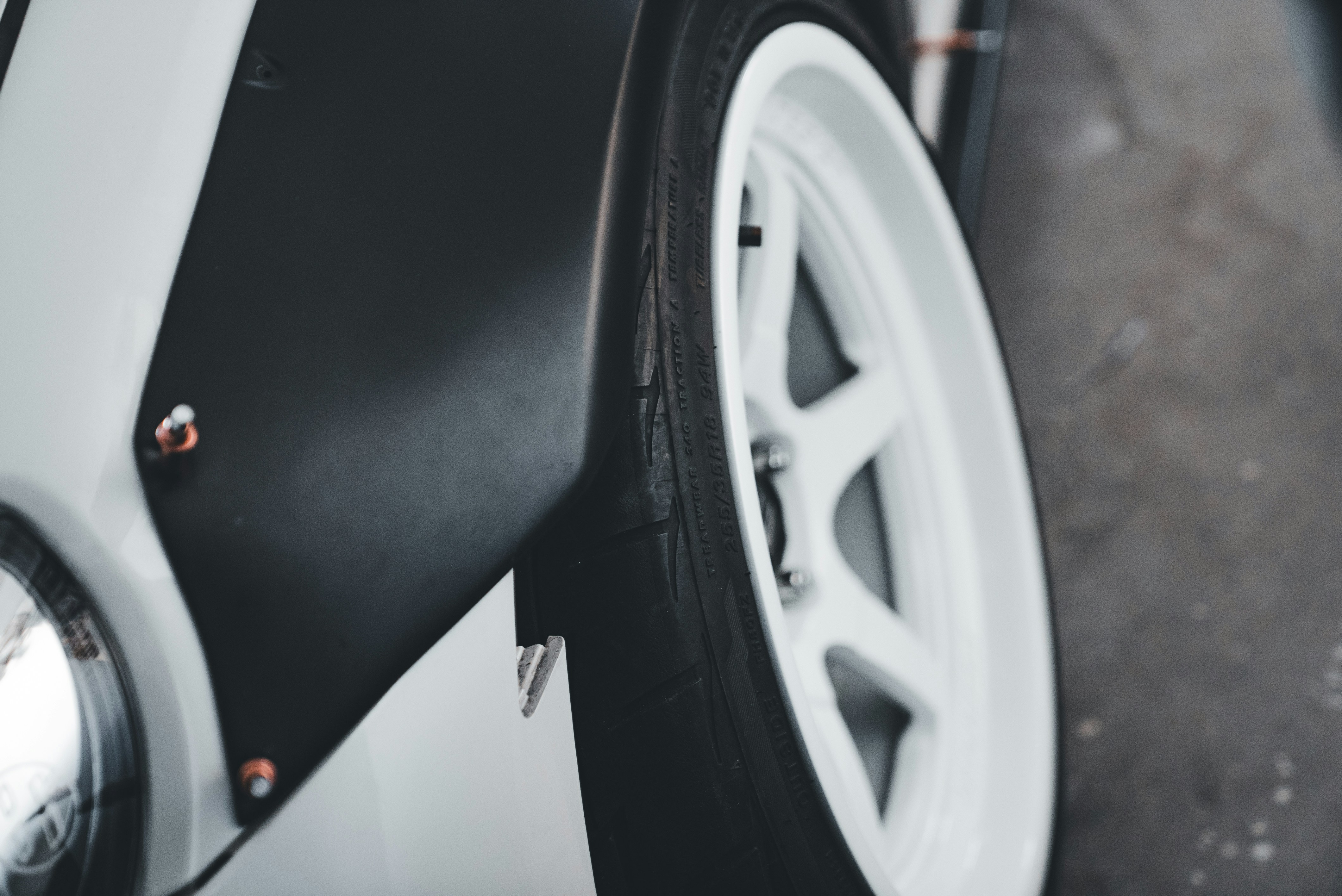Close-up of a white car wheel with black accents