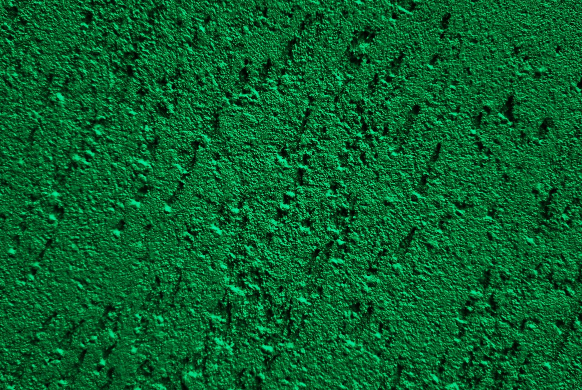 A textured green surface with shadows