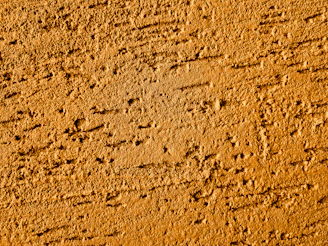 Textured orange wall with rough surface