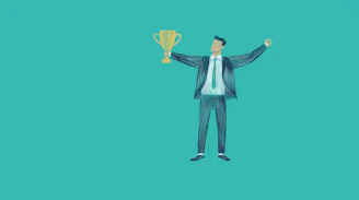 Man in suit holding a trophy with arms raised
