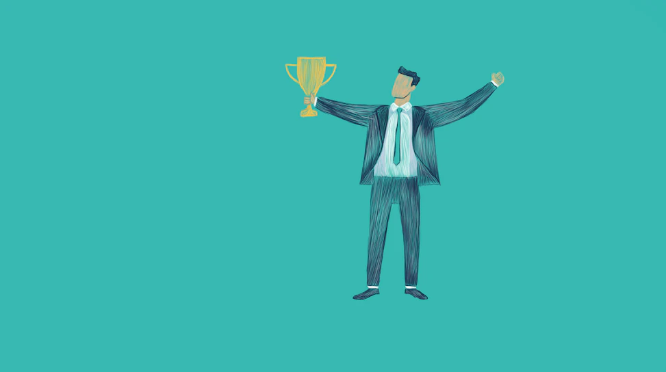 Man in suit holding a trophy with arms raised