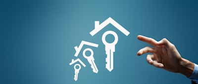 Hand reaching for house and key icons on blue background