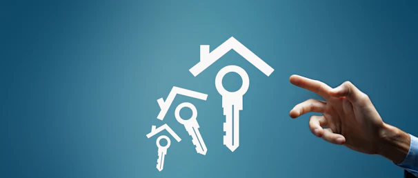 Hand reaching for house and key icons on blue background