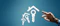 Hand reaching for house and key icons on blue background