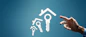 Hand reaching for house and key icons on blue background