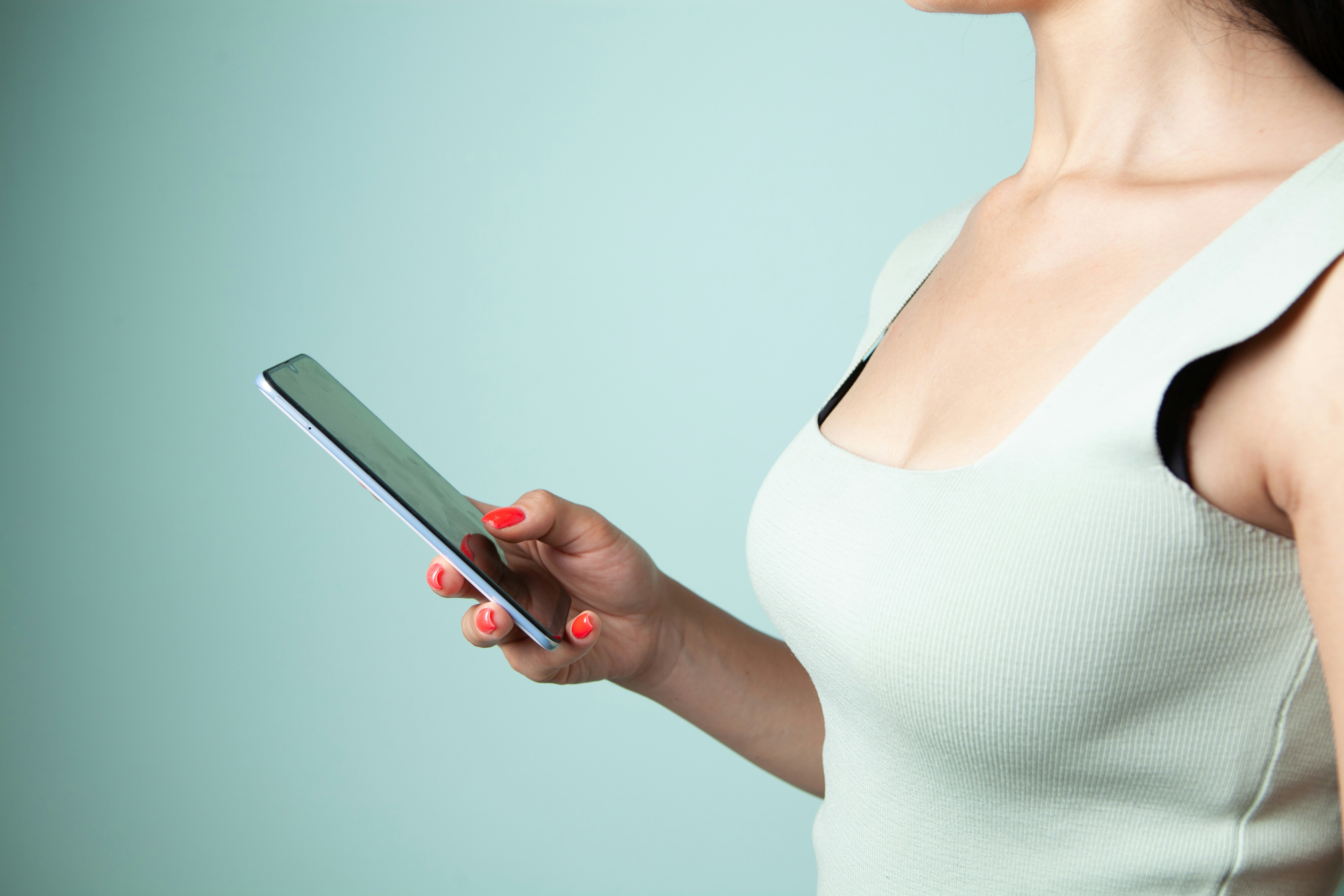 Woman holding and looking at a tablet computer.