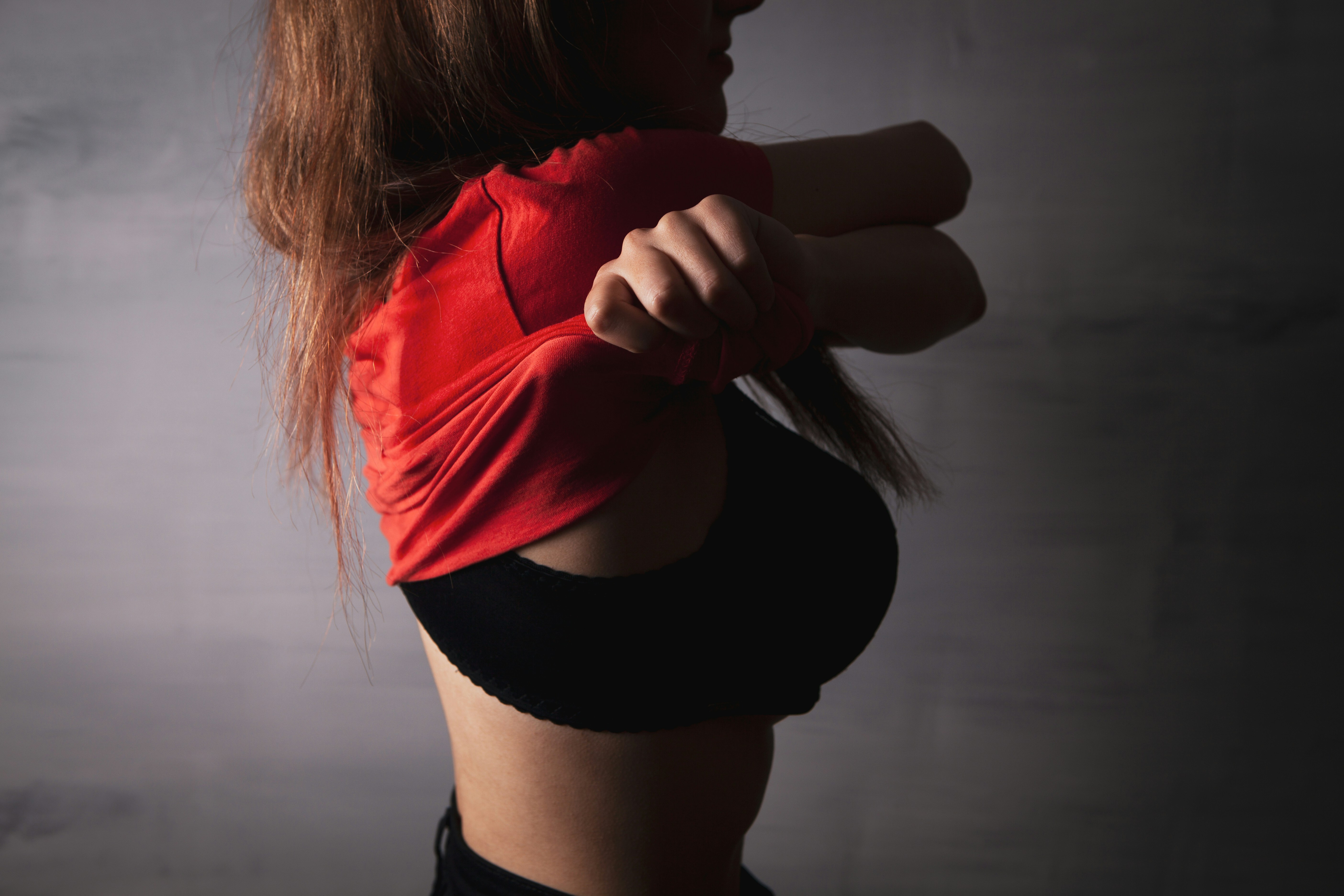 Woman in red shirt pulling it off