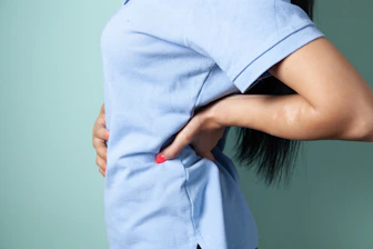 Woman holding her sore lower back