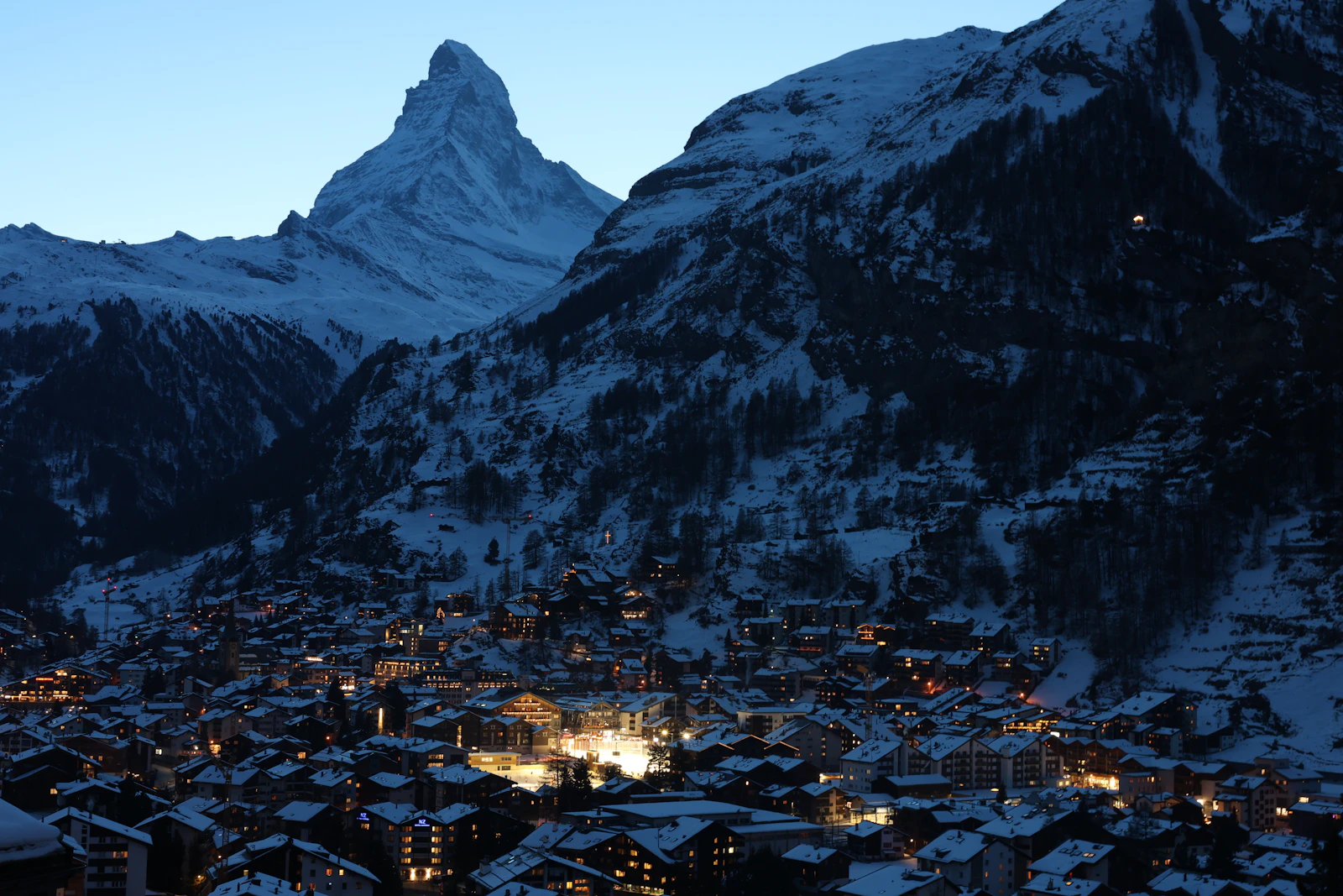 Snowy mountain village with the Matterhorn at dusk