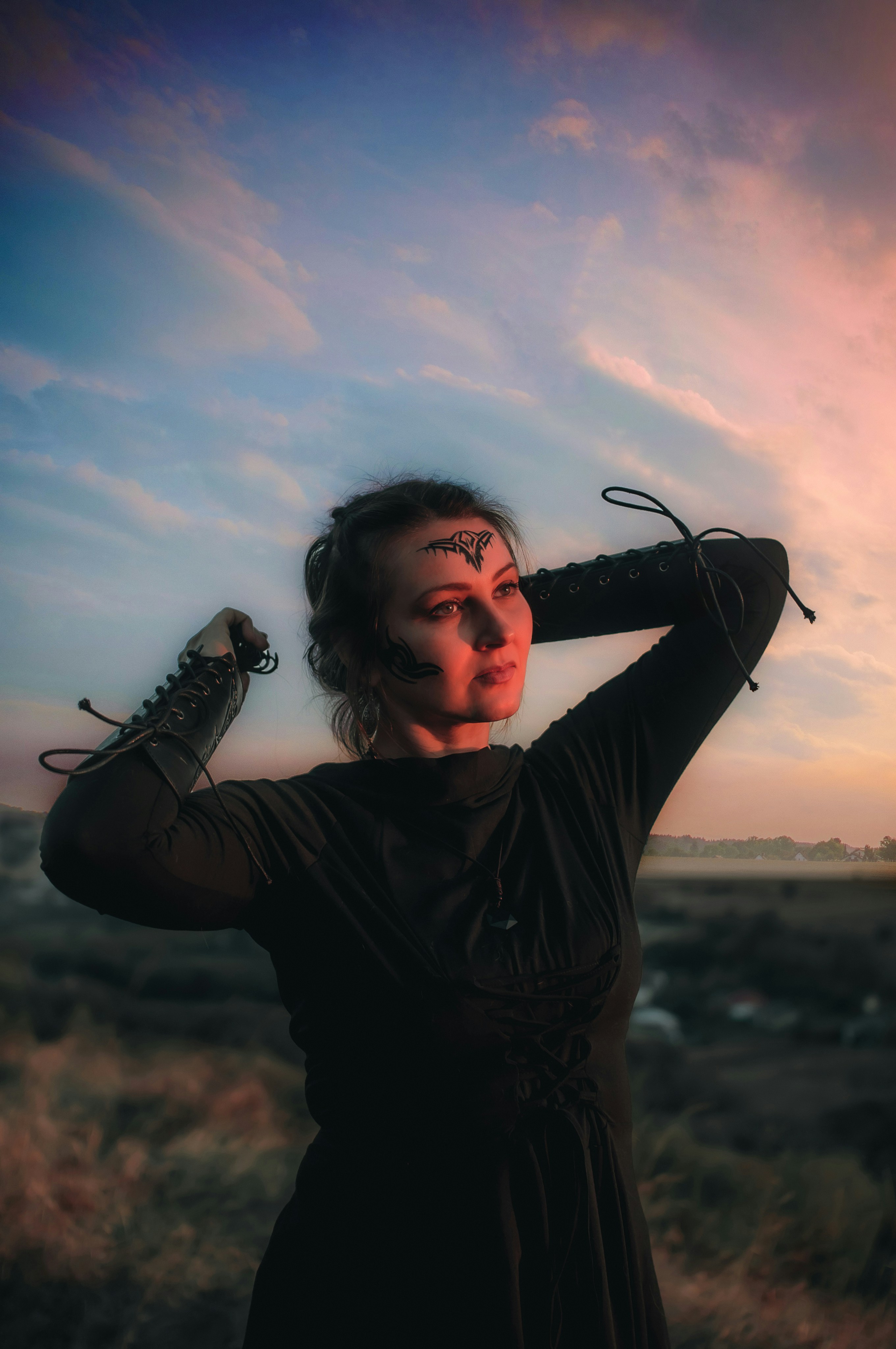 Woman with tribal face paint at sunset