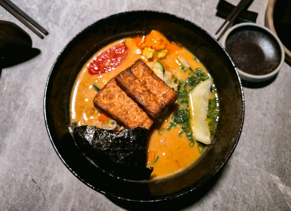 Plant-based ramen with crisp tofu, vegetables, seaweed and citrus