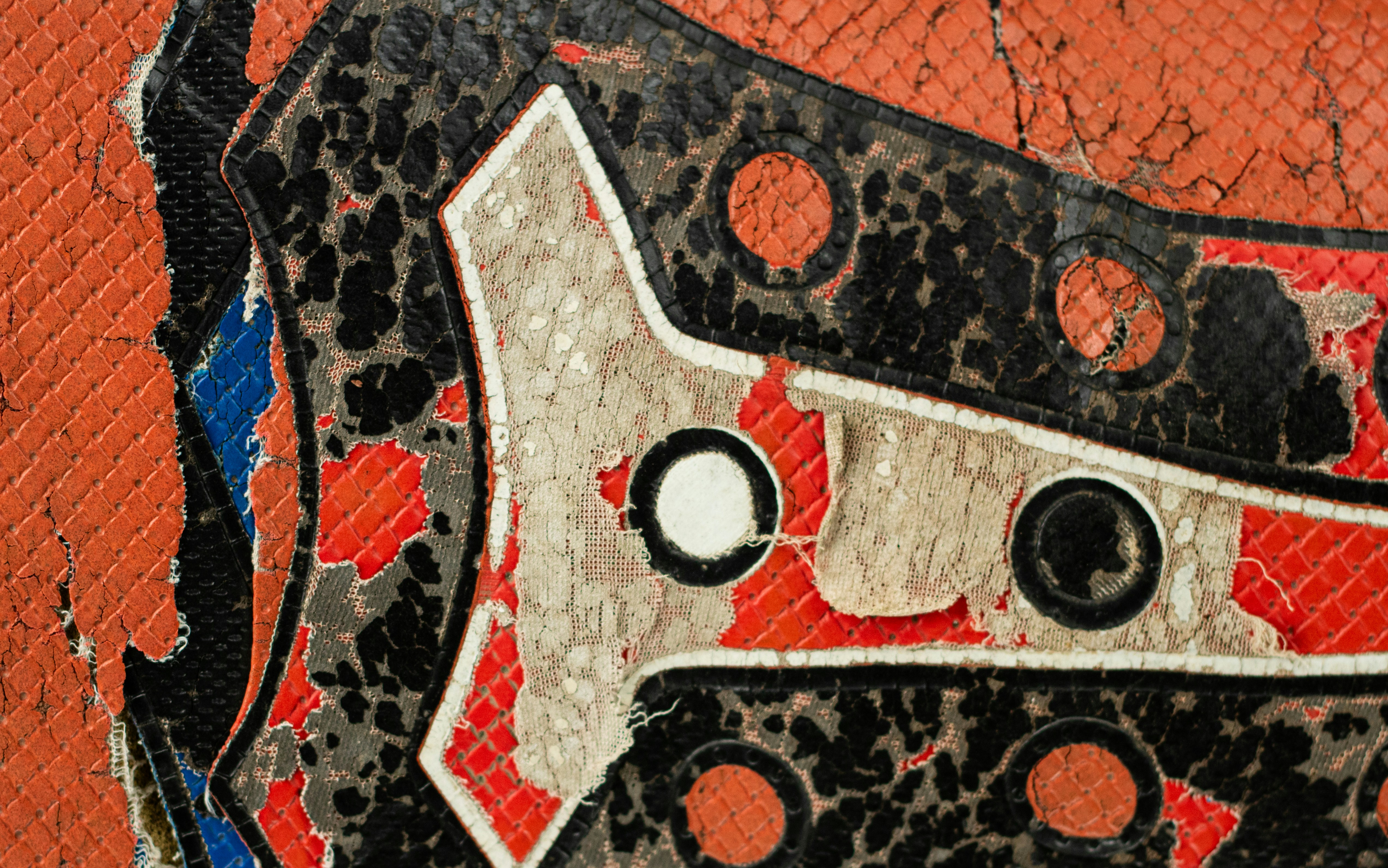 Close-up of distressed orange and black textured material