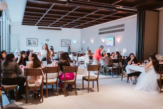 People gathered at tables in a well-lit event space