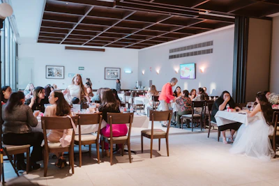 People gathered at tables in a well-lit event space