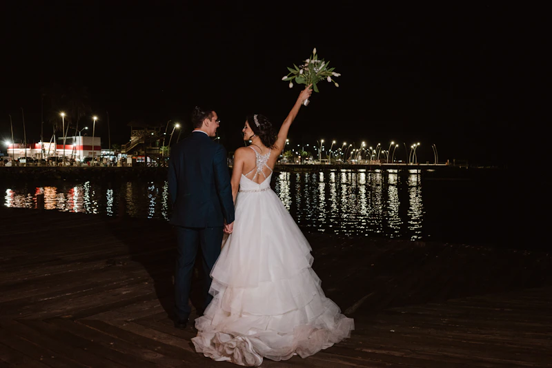 elegant couple celebrating by the water at night