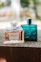 Two perfume bottles on a stone surface.