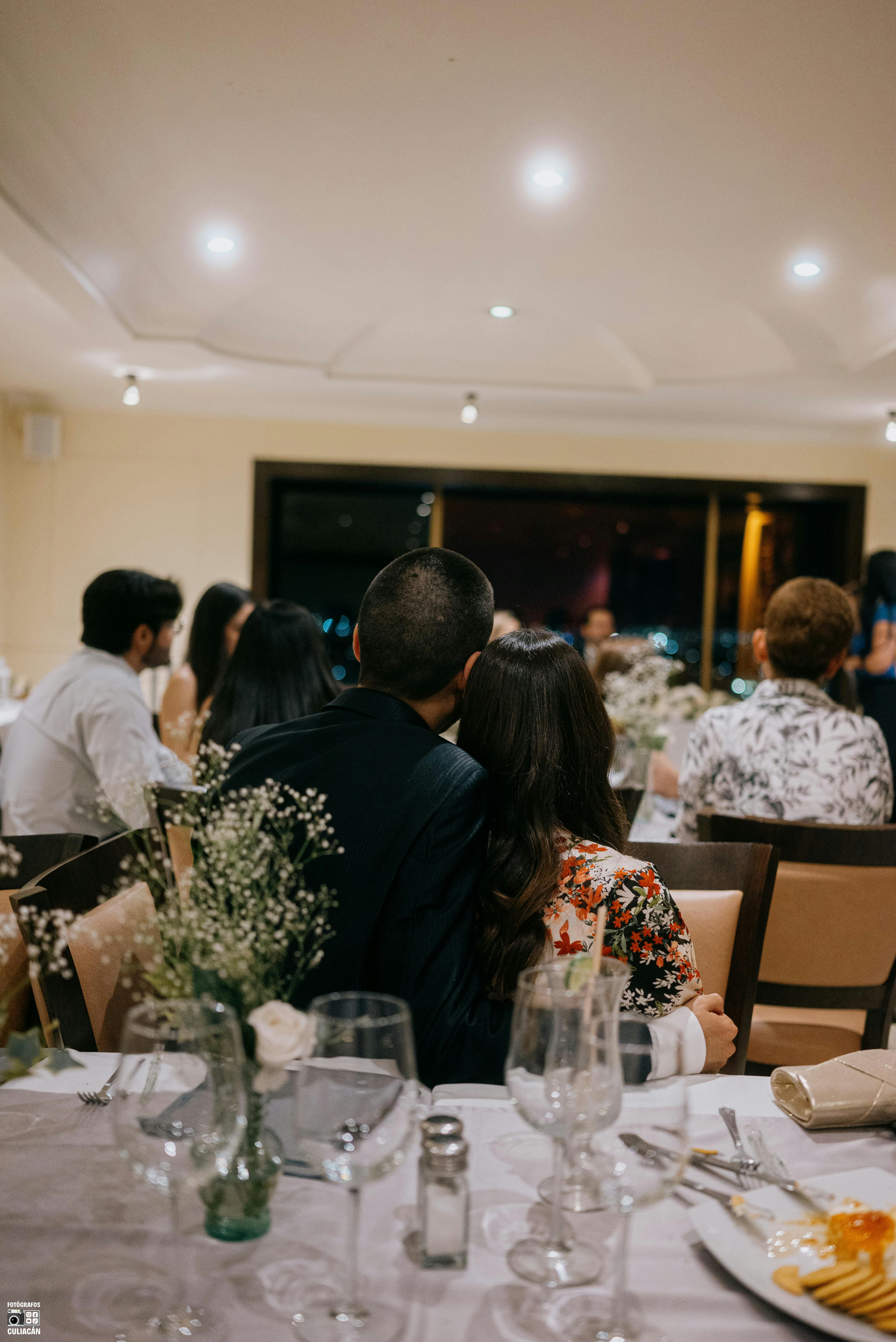 Friends laughing around a wedding table