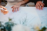 Couple signing marriage documents at a table