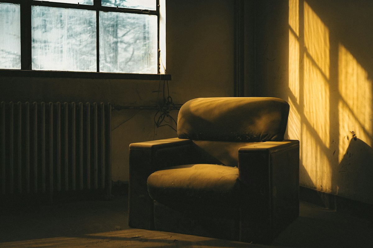Armchair beside a window in soft natural light