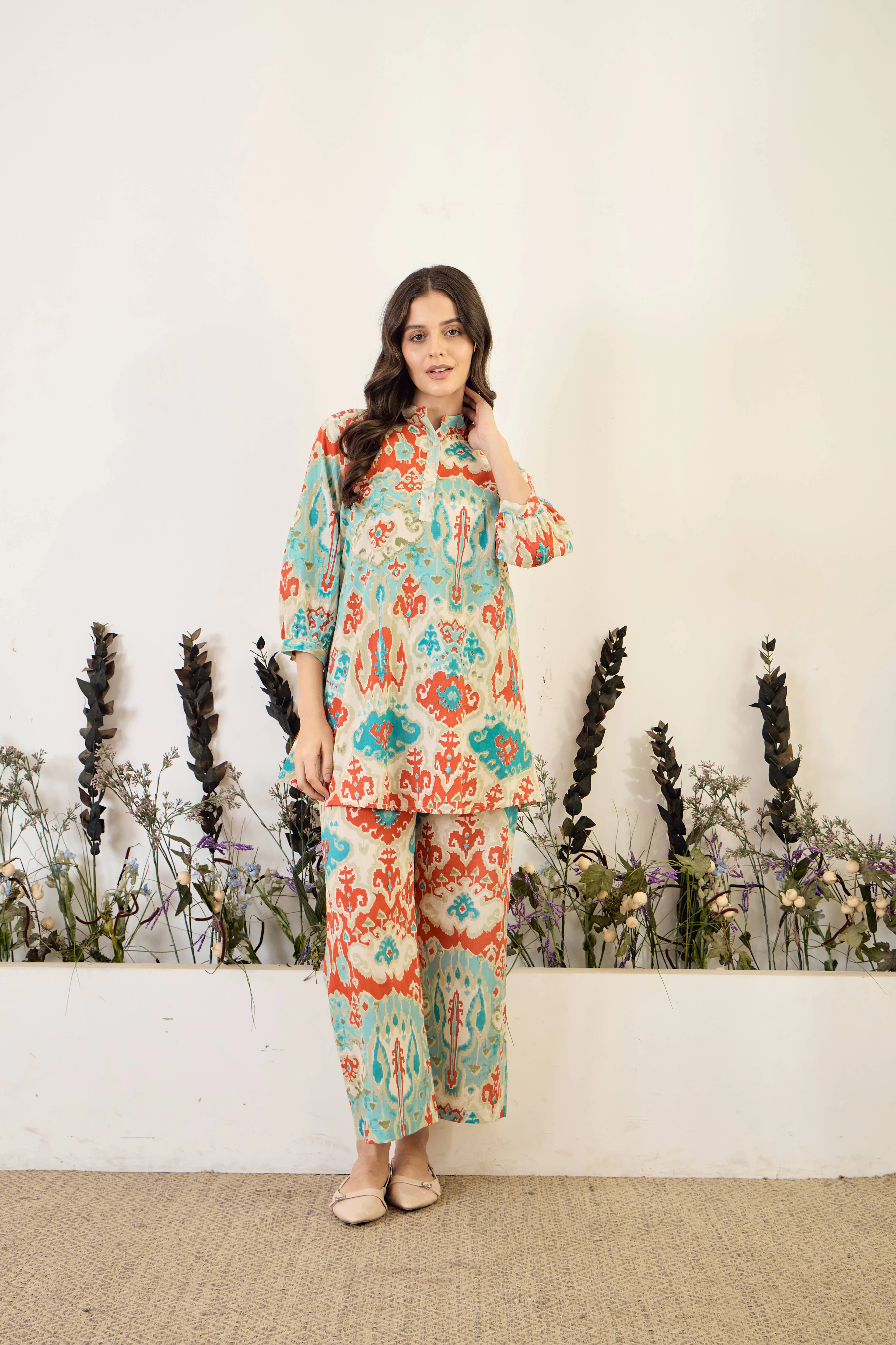 Woman in a turquoise and coral printed co-ord set