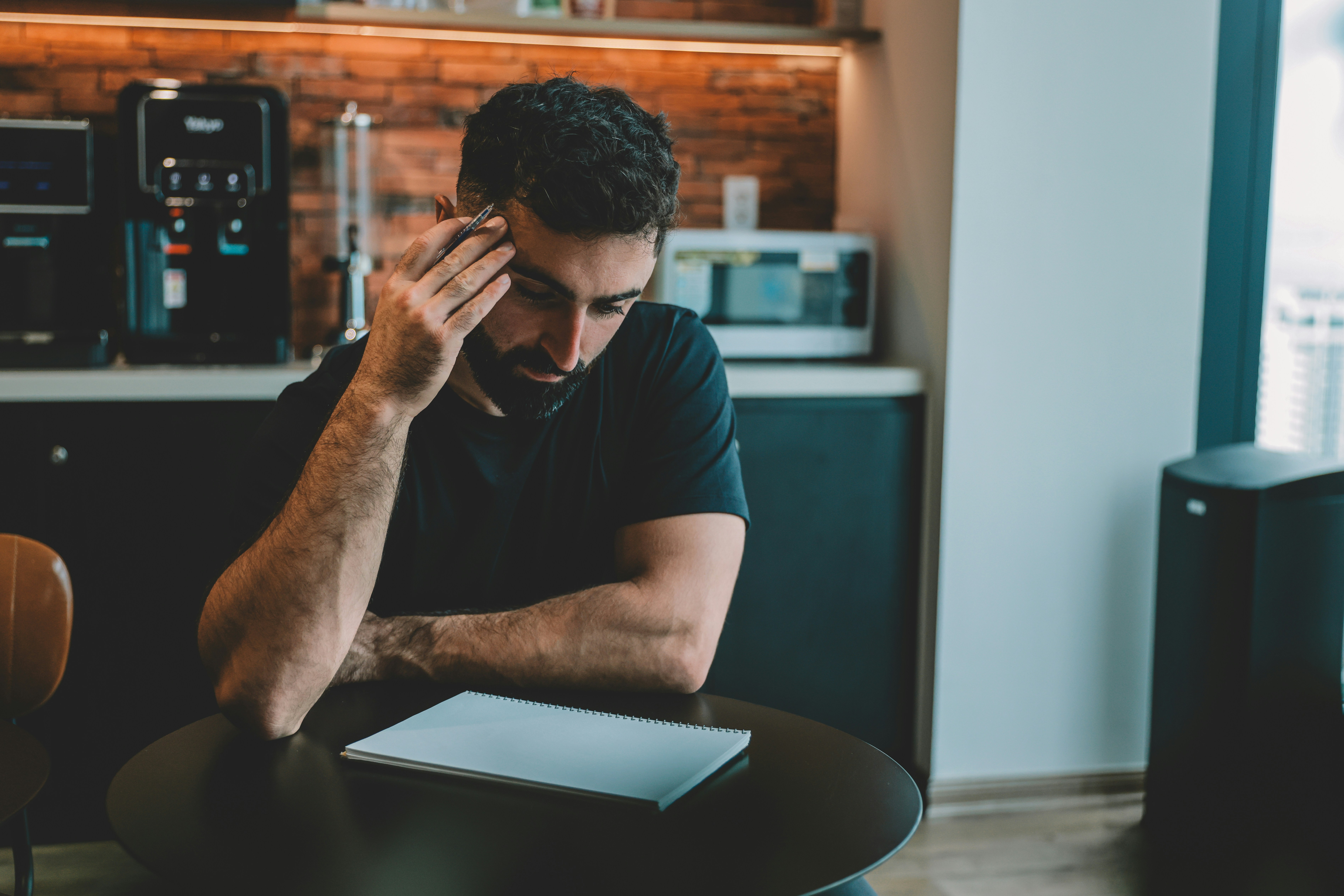 Man holding head while looking at document