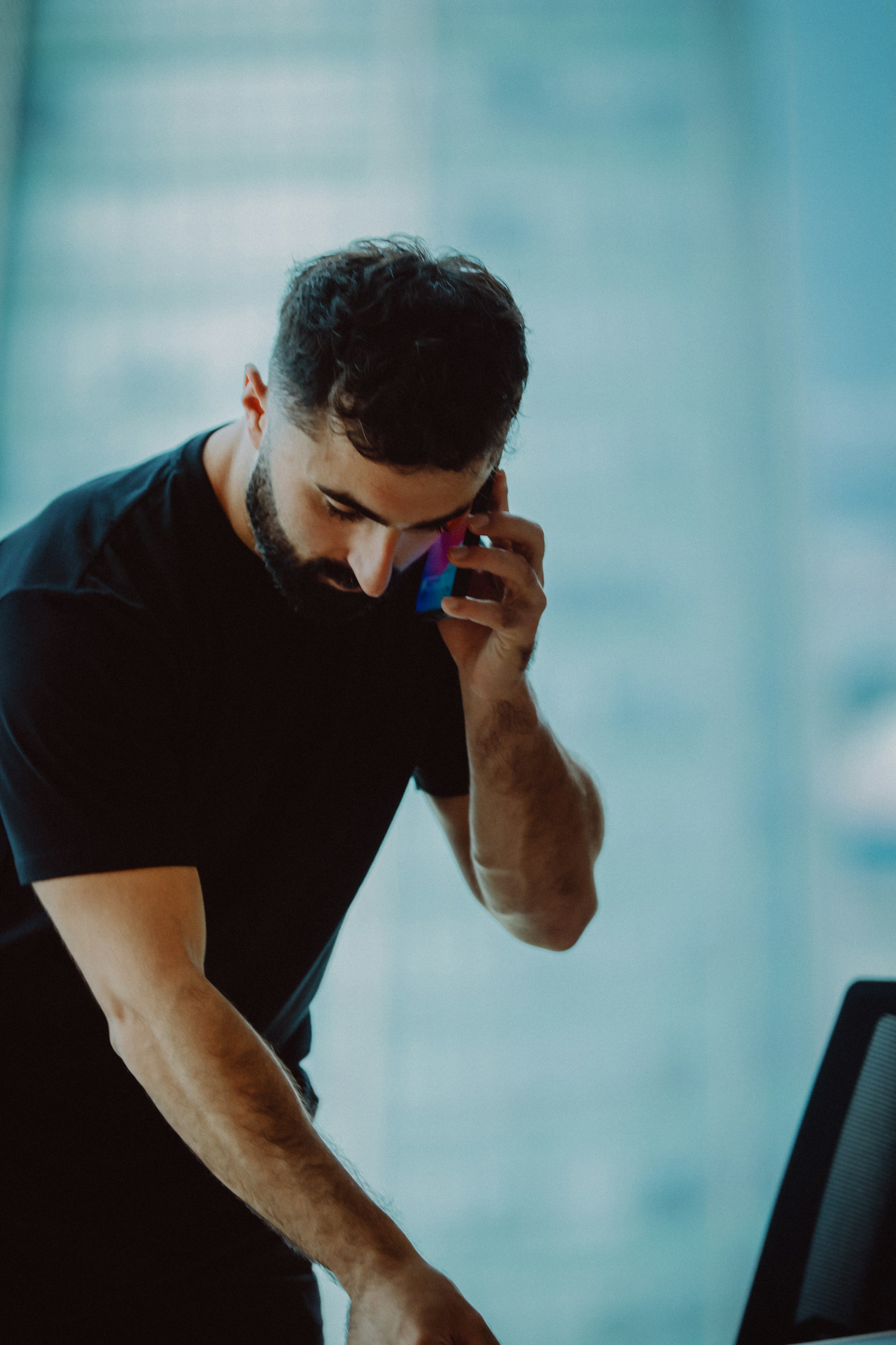 Man in black shirt talking on phone