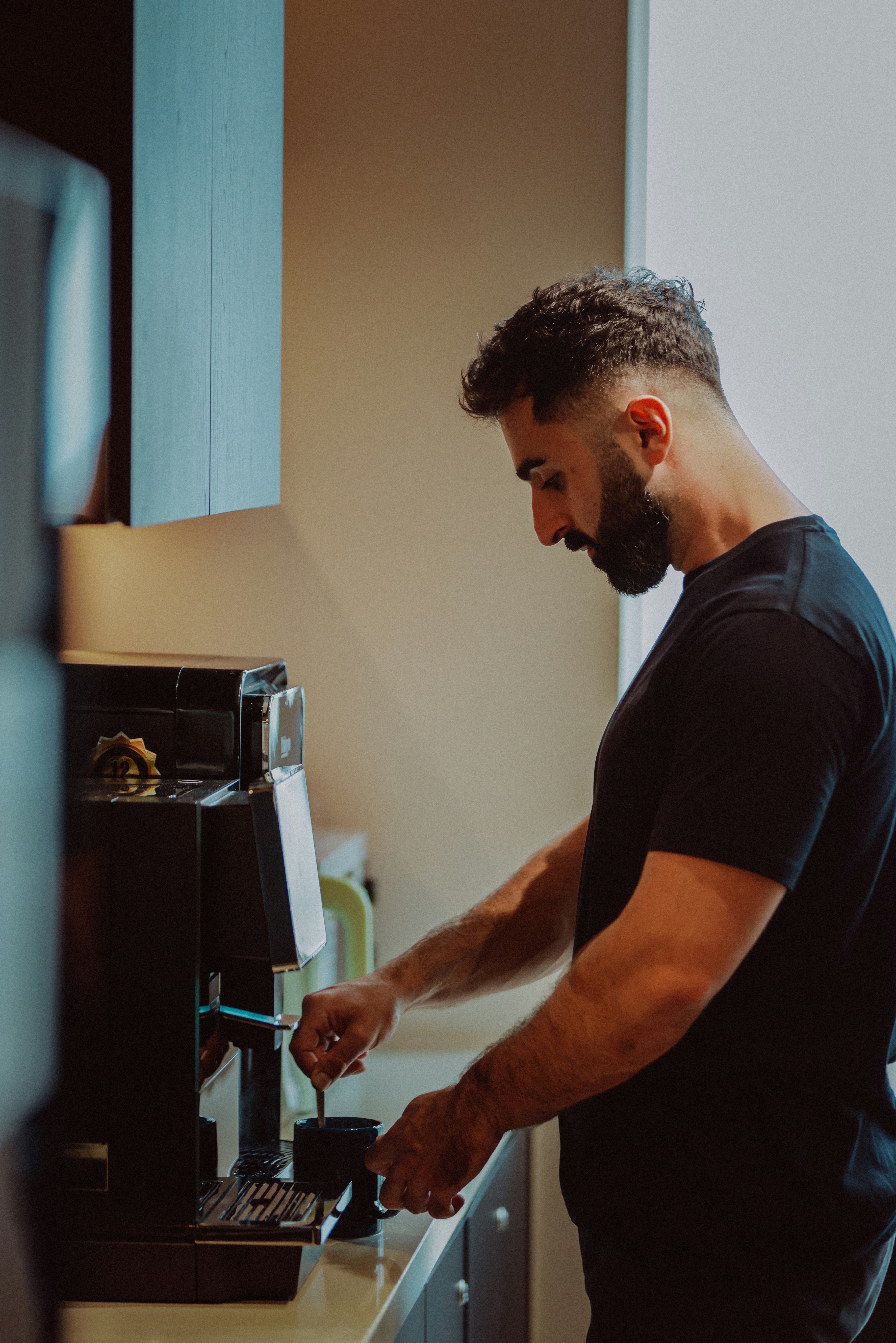 Man preparing coffee with a machine