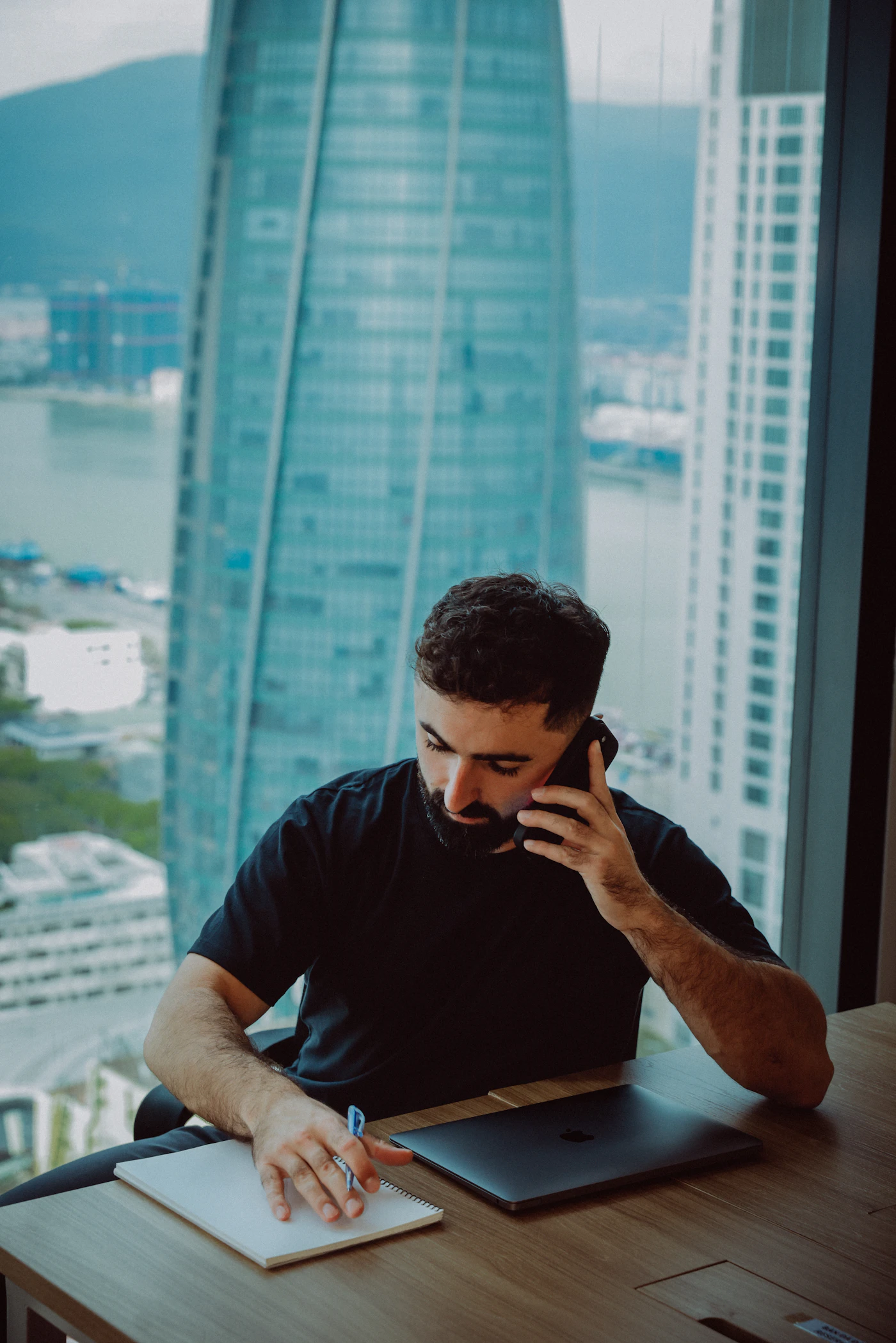 Business professional handling customer calls and enquiry notes