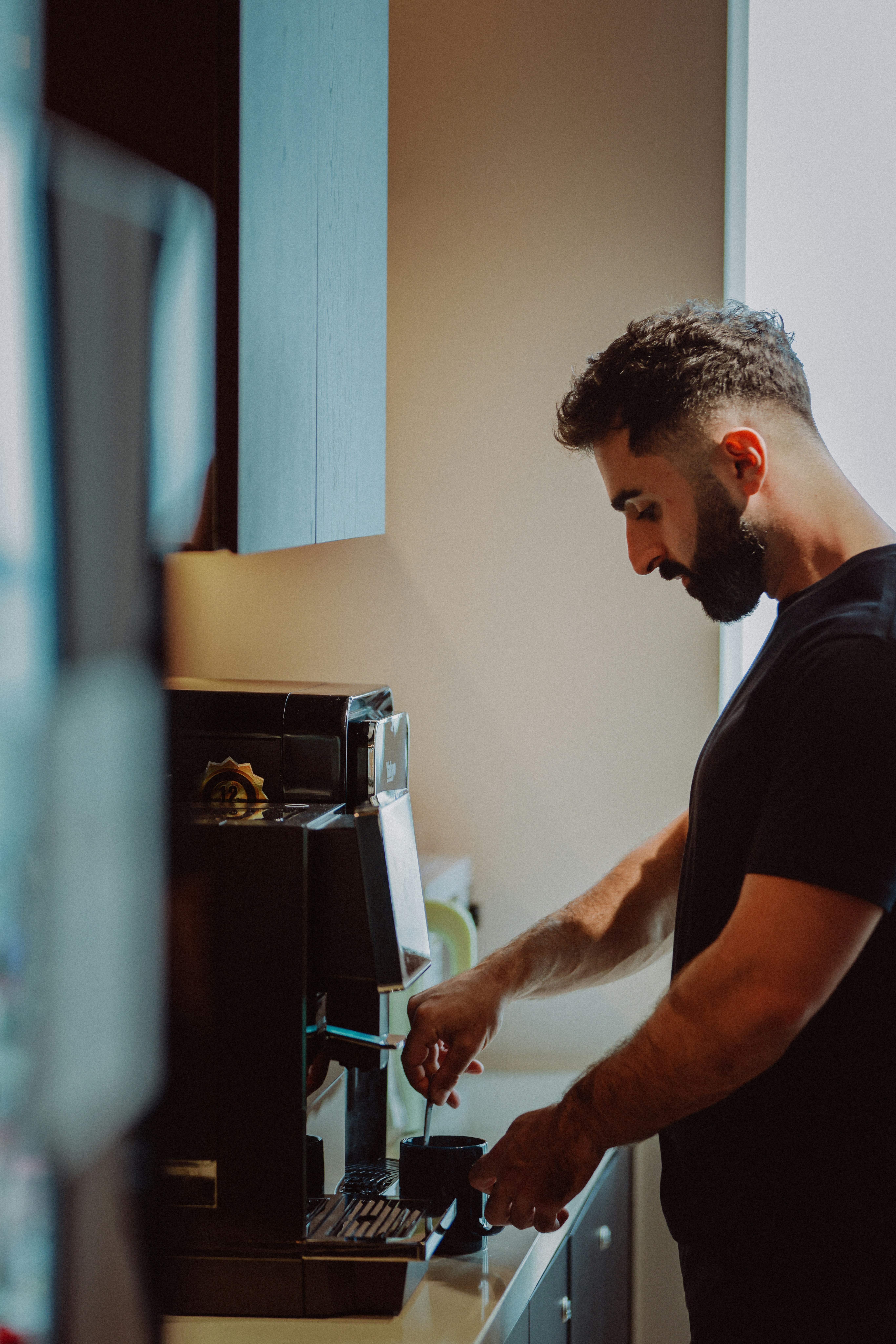 Man preparing coffee with a machine