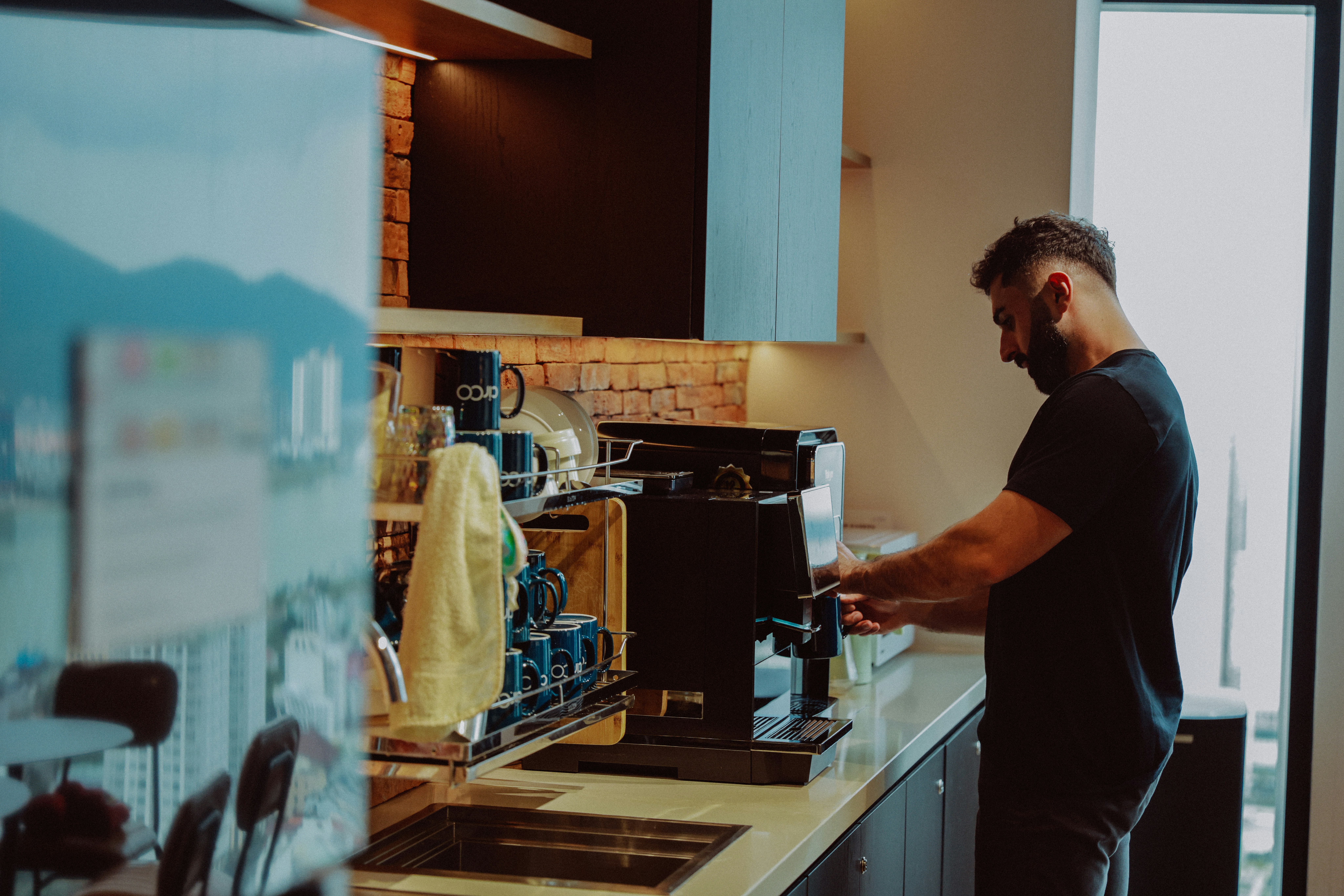 person making latte art with home espresso machine