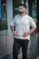 Man with beard wearing white shirt and black pants