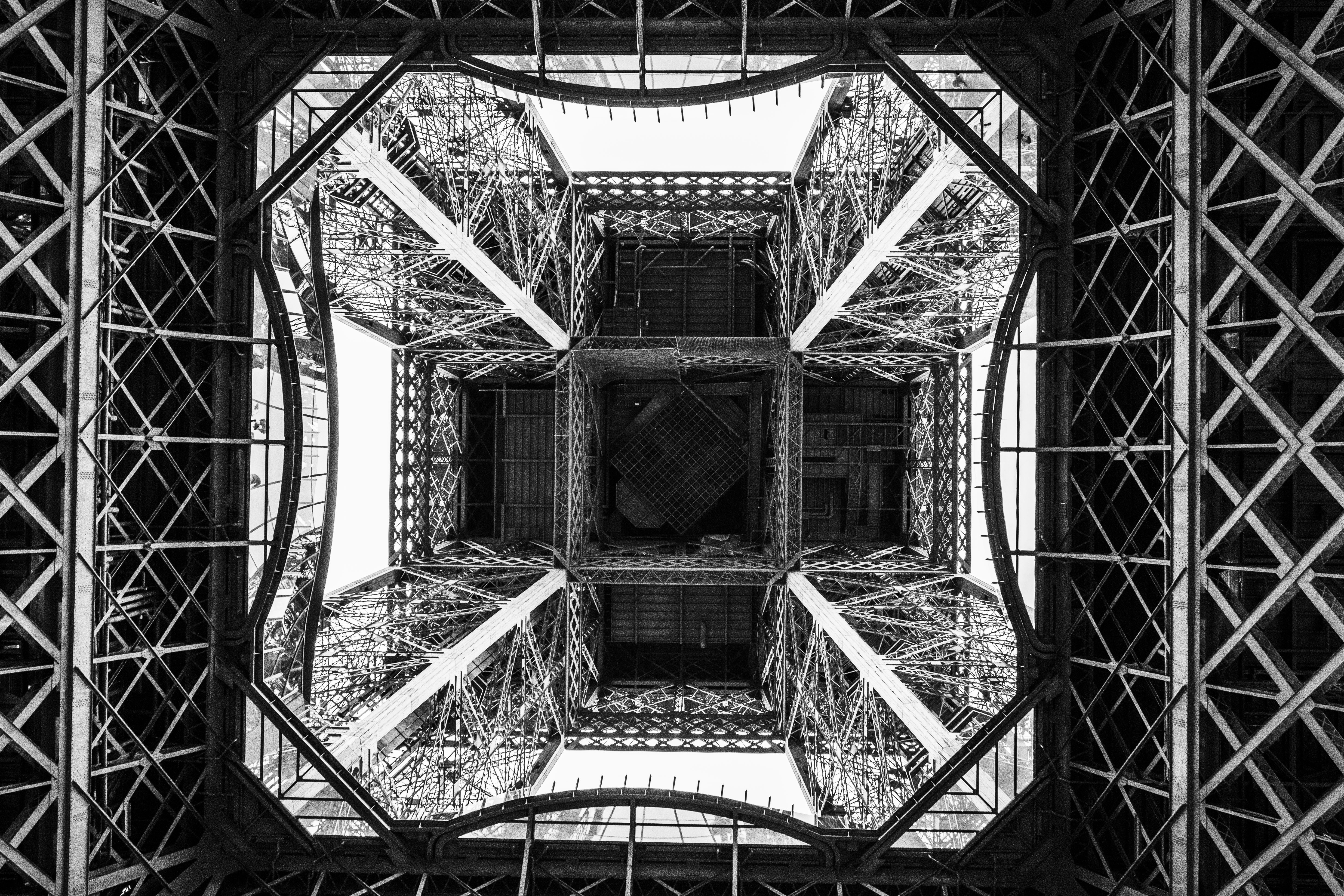 Looking up at the eiffel tower's intricate metal structure